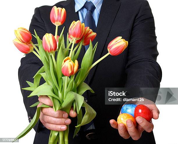 Man In Suit With Tie Gives Easter Eggs And Tulips Stock Photo - Download Image Now - Adult, Adults Only, Black Color