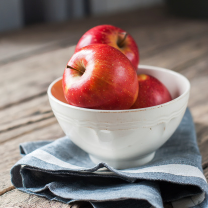 Composition with Red Apples on the dark wooden table, square image