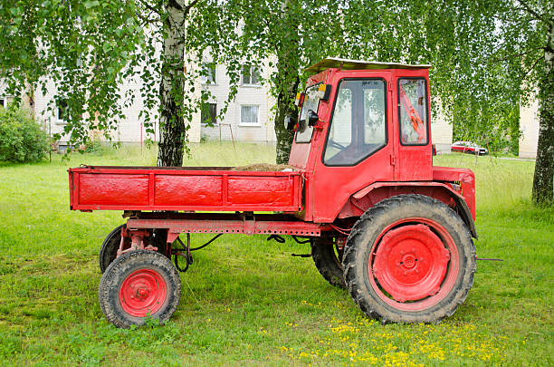 istock Retro red agricultural tractor under birch trees 177769970