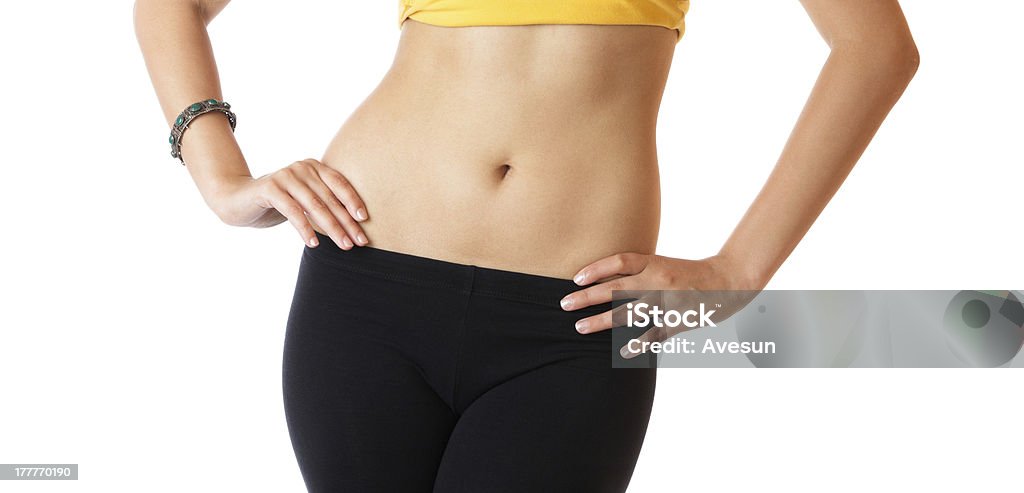 Slender young woman Slender young woman with flat abs and slim waist isolated over white background Abdomen Stock Photo