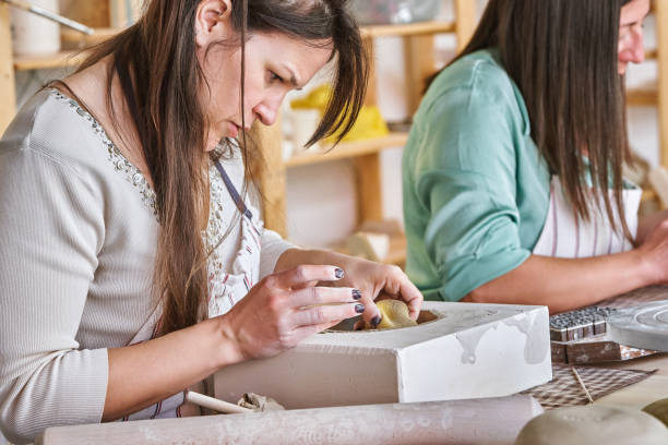 istock Woman working with clay while making a pottery craft in a workshop. 1777702341