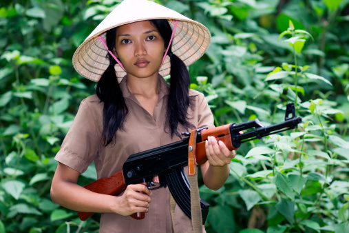 Asian woman armed in nature