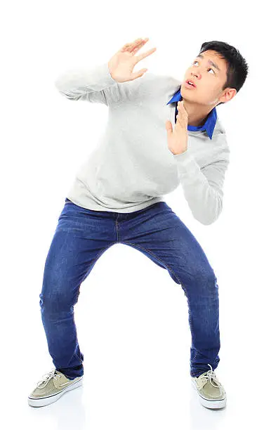 Photo of Asian Boy Holding Out His Hands To Avoid Danger
