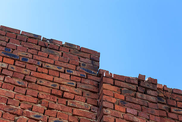 istock Old grunge red brick wall against blue sky 177770982