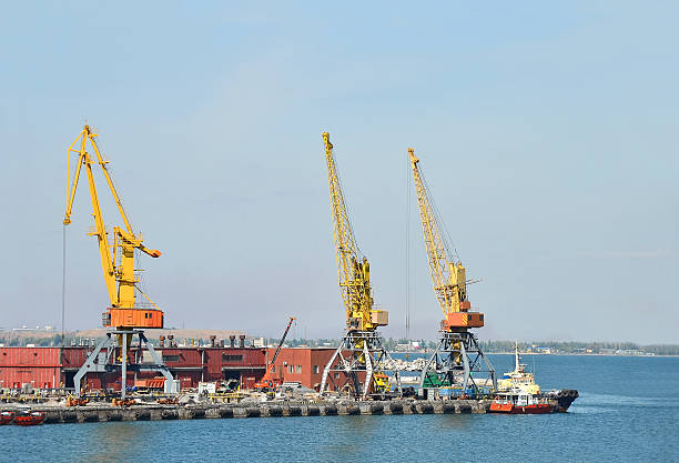 istock Tugboat and freight train under port crane 177771343