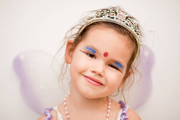 Beautiful princess little girl smiling lying on the floor