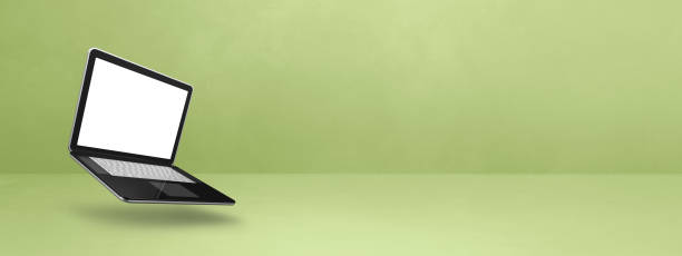 istock Floating computer laptop isolated on green. Horizontal banner background 1777745820