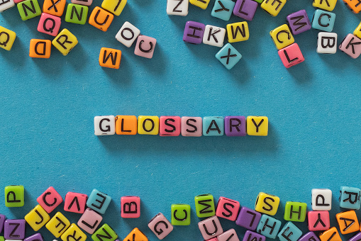 Glossary word concept with multicolor letters on blue