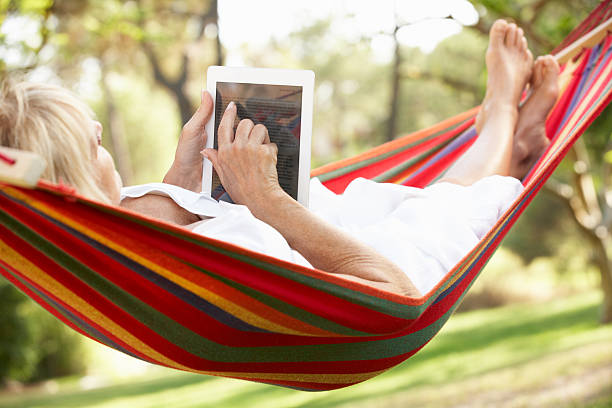 istock Older woman relaxing in the Hammock with a tablet 177775182
