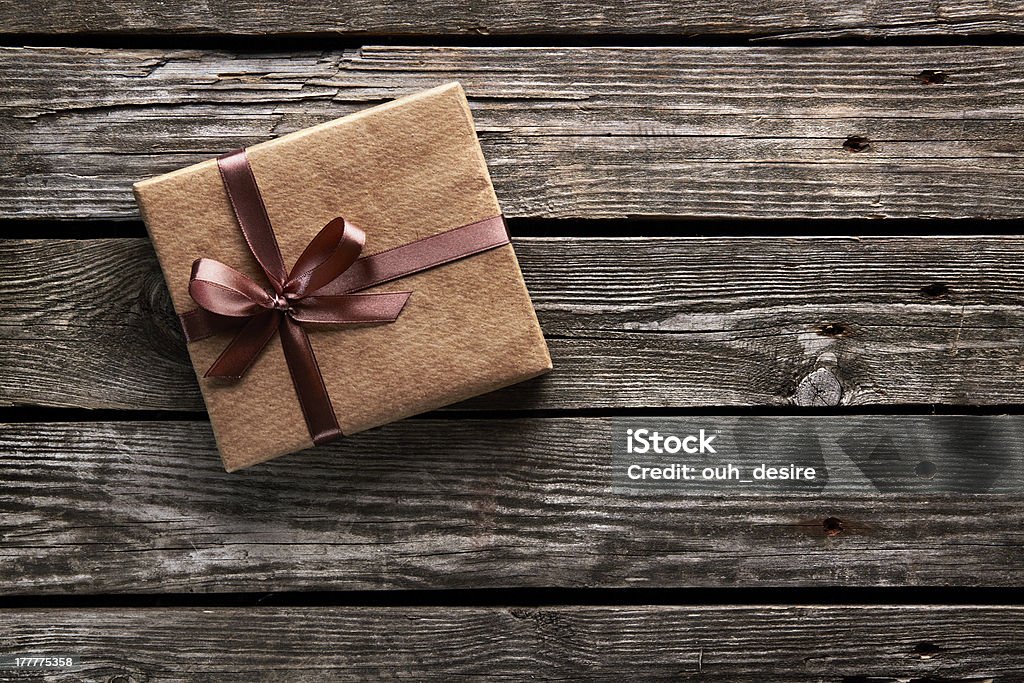 Vintage gift box on old wood Vintage gift box of craft paper. On old wooden background. Art And Craft Stock Photo