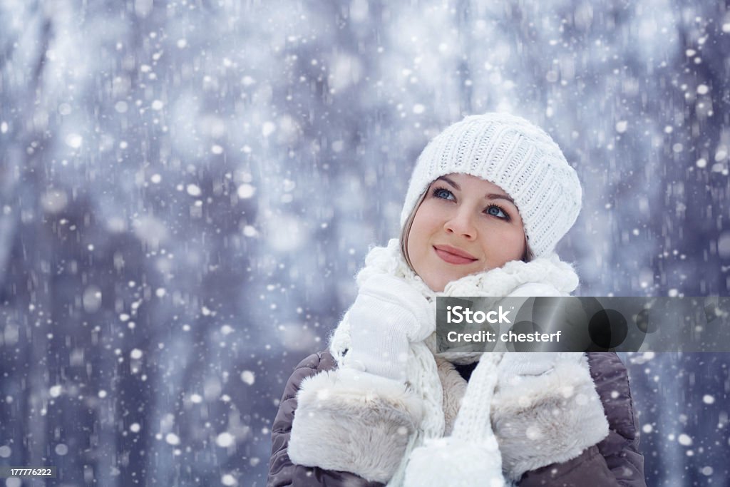 beautiful woman walking outdoors under snowfall beautiful blonde woman walking outdoors under snowfall Adult Stock Photo