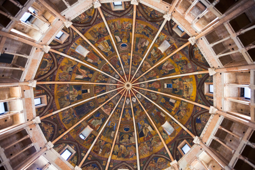 the middle of painted ceiling of The Baptistery. All painted scene are 13th and 14th century frescoes and paintings, in Parma, Italy on November 3, 2012