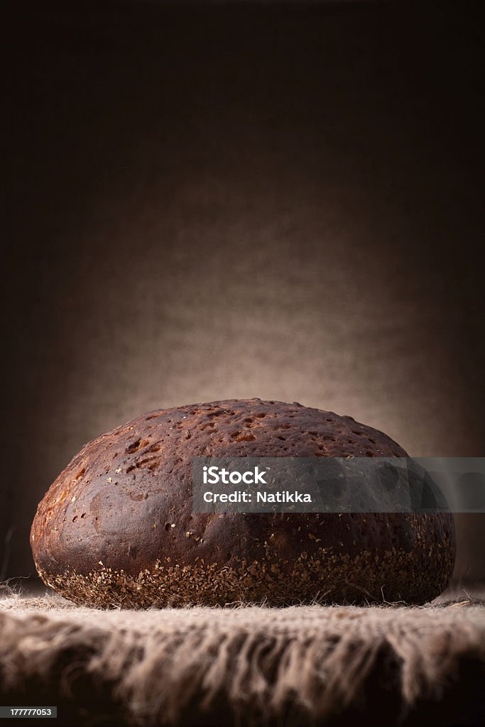 Loaf of rye bread Loaf of rye bread on rustic background Baked Stock Photo