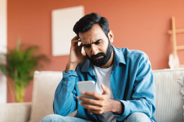 istock Portrait Of Indian Man Using Smartphone Having Problem At Home 1777778378