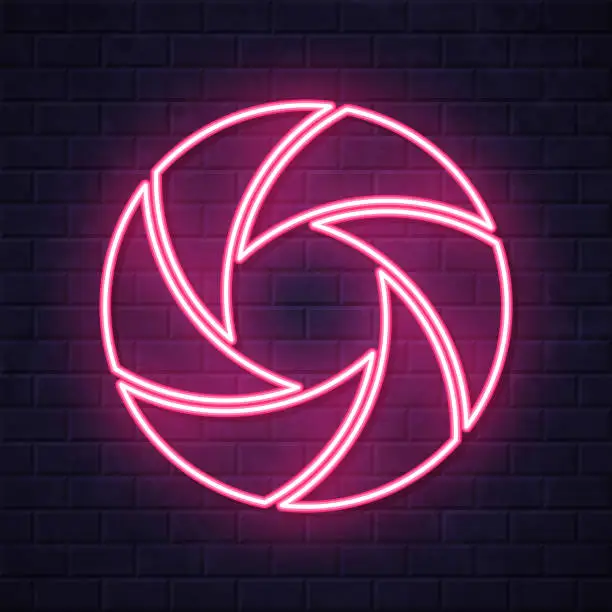 Vector illustration of Camera shutter. Glowing neon icon on brick wall background