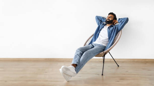istock Indian man relaxing with hands behind head in armchair indoor 1777779064