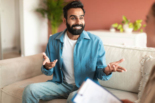 istock Cheerful Arab Guy Talking To Specialist Advisor Woman In Office 1777779581