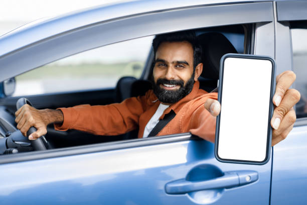 istock Arab Guy Driving Showing Phone Blank Screen Through Car Window 1777779652