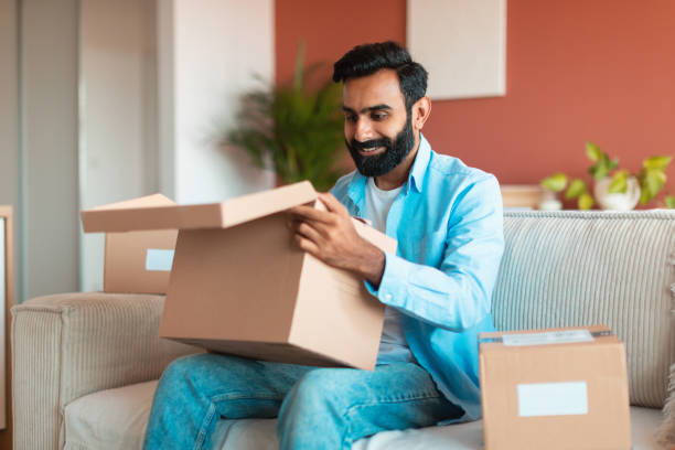 istock Happy Middle Eastern customer man opening cardboard boxes at home 1777780285