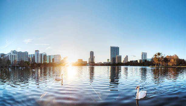 A view of buildings and water in Miami Orlando at Lake Eola Park at Sunset. lake eola stock pictures, royalty-free photos & images