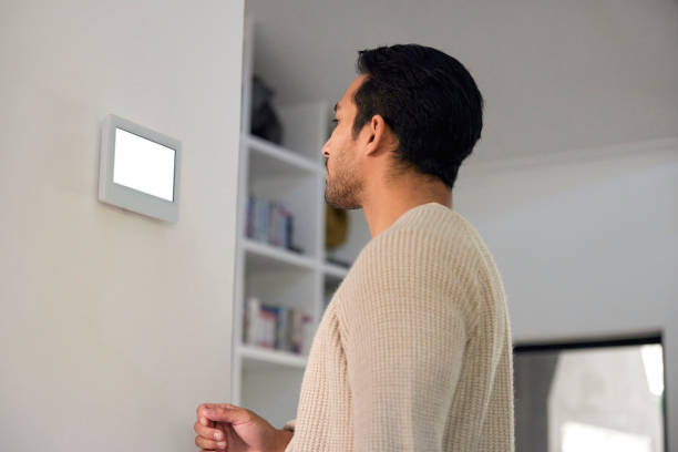 istock Handsome Man Pauses, His Eyes Reflecting a Moment of Thoughtfulness at the Intercom 1777803365