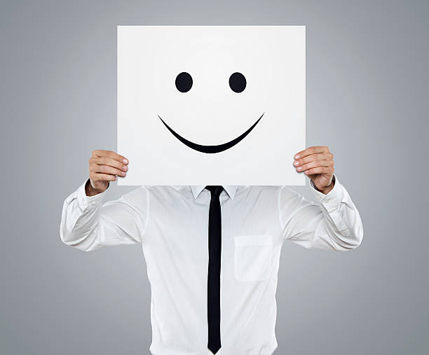 istock Businessman holding white card with emoticon on it 177780448