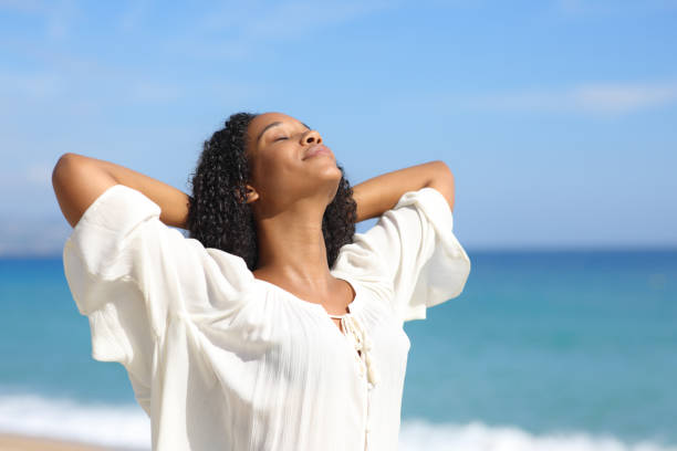 istock Black woman relaxing breathing on the beach 1777805873
