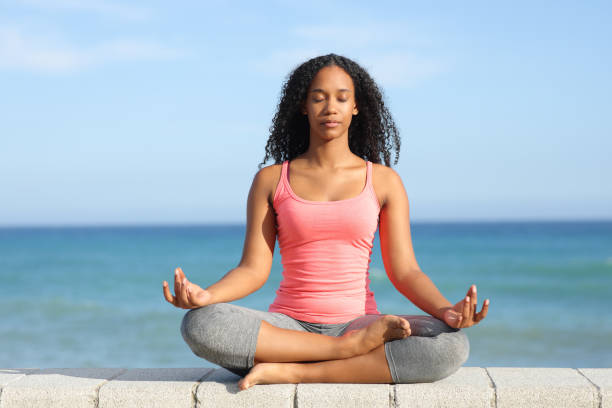 istock Black woman doing yoga exercise on the beach 1777806910