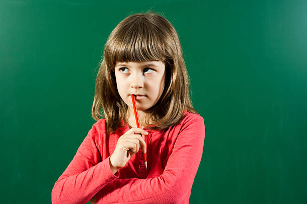 petite fille penser - blackboard child thinking little girls photos et images de collection