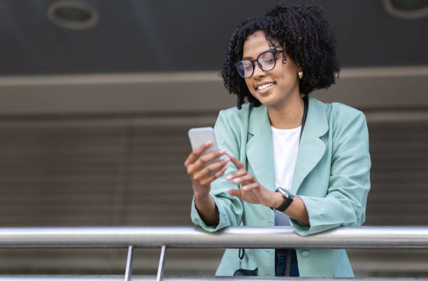 istock Positive young black woman employee using phone next office building 1777817371