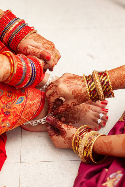 istock An Indian bride gets her silver anklets put on by another woman. 1777823038