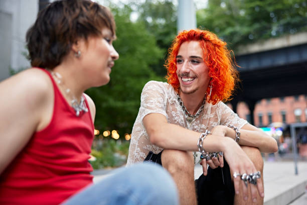 istock Young LGBTQIA friends sitting outdoors and talking 1777823604
