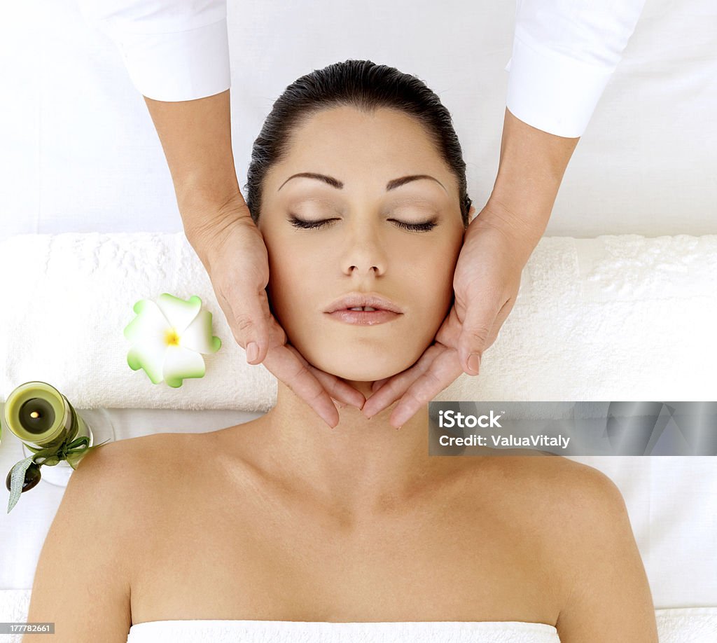 Woman having massage of head in spa salon Woman having massage of head in the spa salon. Beauty treatment concept. Adult Stock Photo