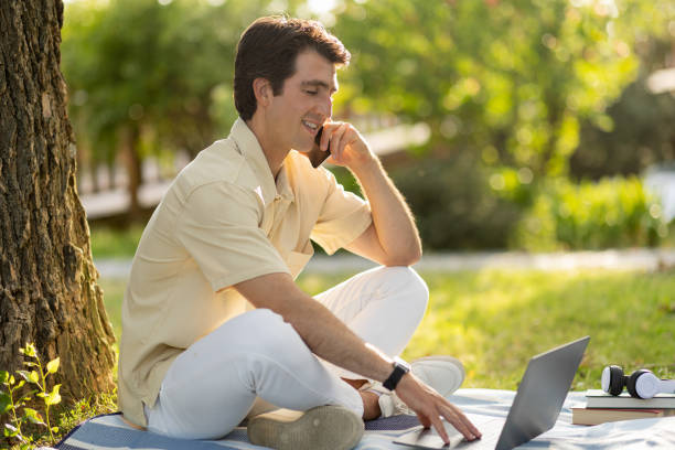 istock Young independent contractor working at public park, have phone call 1777829727