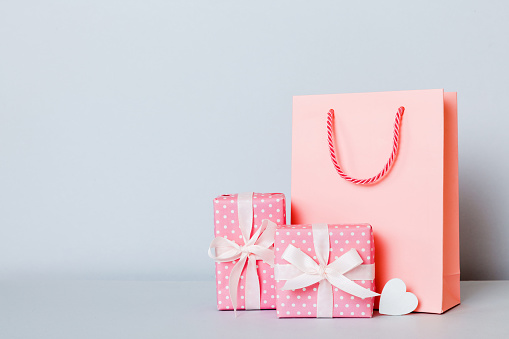 Brown gift box with pink ribbon isolated on white background. High resolution 42Mp studio digital capture taken with Sony A7rII and Sony FE 90mm f2.8 macro G OSS lens