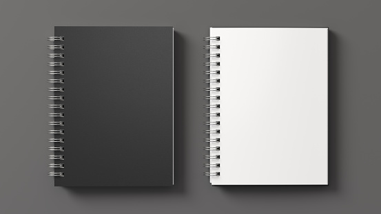 Notebook mockup. Closed and open blank notebook with black cover. Spiral notepad on gray background. 3d illustration