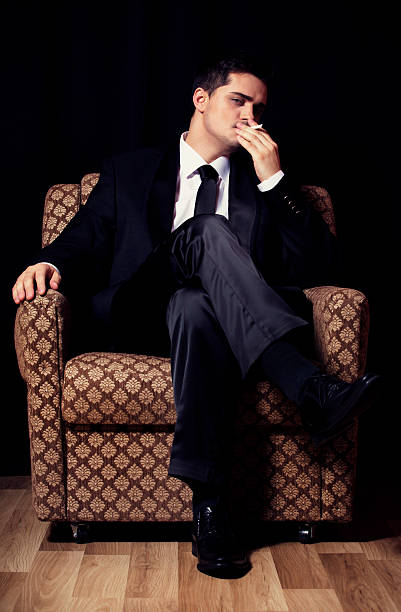 istock Man with cigarette sitting in vintage armchair 177784797