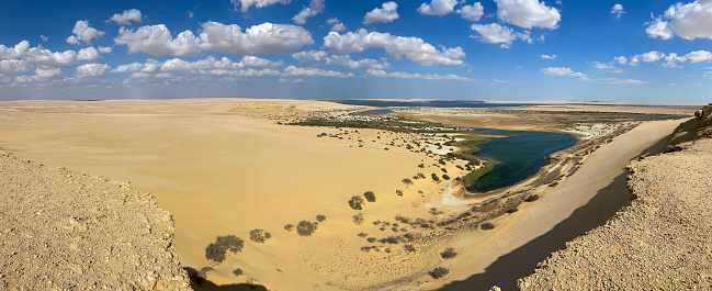 Detail of building in front of sand dune in Sahara desert. Morocco, Africa.