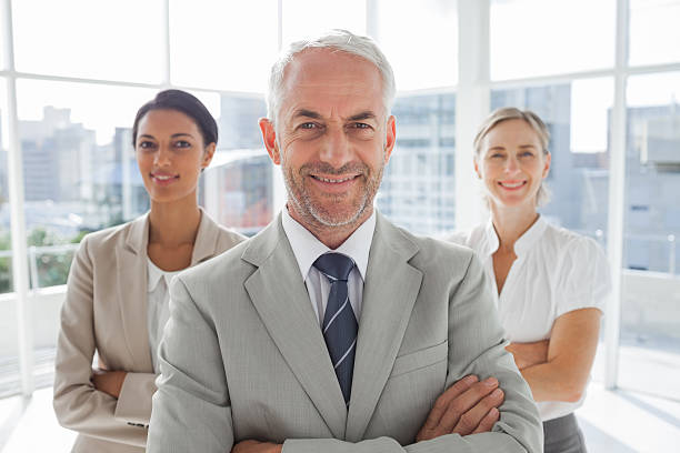istock Smiling businessman standing in front of colleagues 177785955
