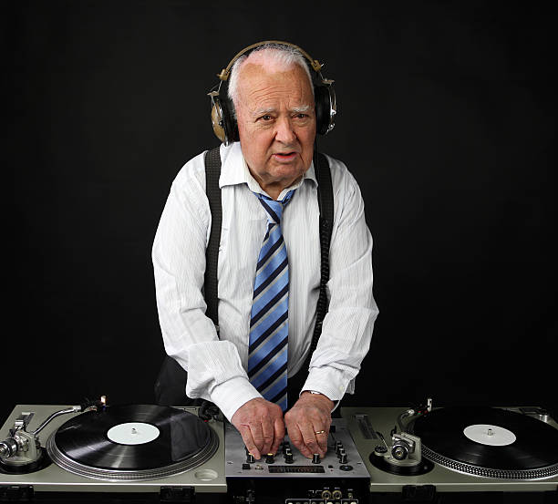 istock Senior man wearing a tie and performing as a DJ 177786406
