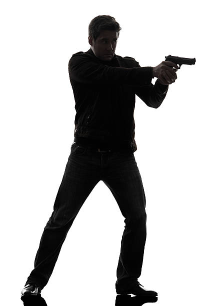 istock man killer policeman aiming  gun standing silhouette 177786648