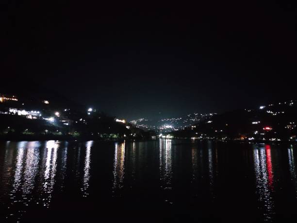 istock lights are reflecting off the water at night time on a dark river 1777875723