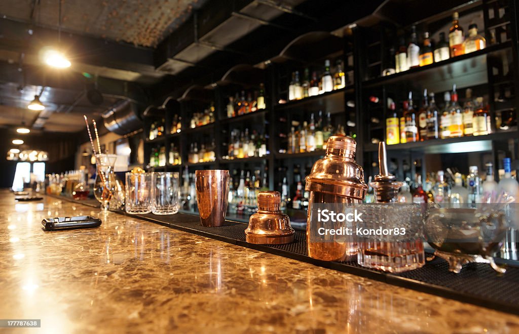 Classic bar counter Classic bar counter with bottles in blurred background Bar - Drink Establishment Stock Photo
