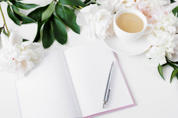 istock Morning coffee cup, diary and white peonies flowers on white table 1777877370