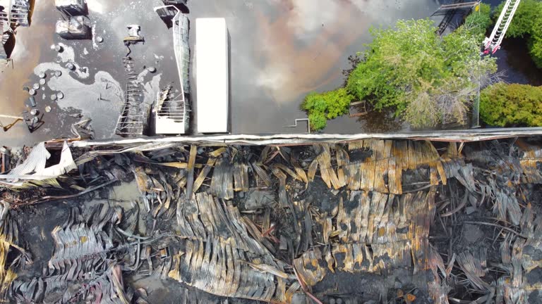 descending above the gutted shell of a chemical factory after fire swept through