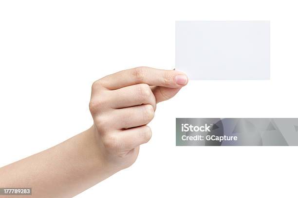 Female Teen Hand Holding Blank Paper Card With Two Fingers Stock Photo - Download Image Now