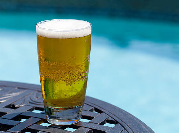 istock Glass of beer on table by poolside 177789392