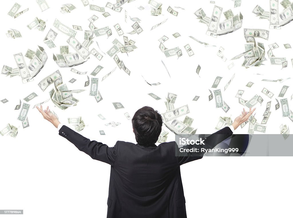 Businessman stands with arms out as money falls back view of business man hug money isolated on white background, concept for success business, asian model Currency Stock Photo