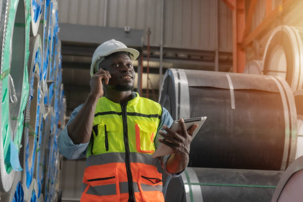 istock Factory manager tracking delivery details using digital pad while chatting on smartphone in warehouse 1777900801