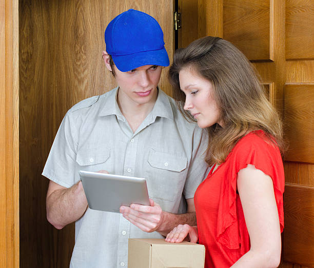 istock Young courier deliver package to pretty woman 177790127